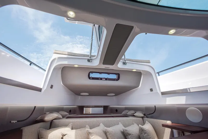Slide: The Image of 2023 Axopar 45 Cross Cabin interior with skylight and plush seating. - 31
