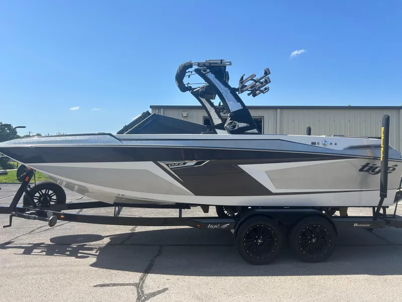 Slide: The Image of 2024 Tigé 22RZX boat on trailer, sleek design, sunny day. - 0