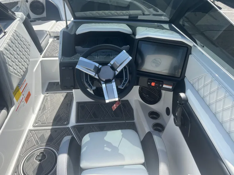 Slide: The Image of 2024 Tigé 22RZX boat interior with modern steering and touchscreen display. - 9