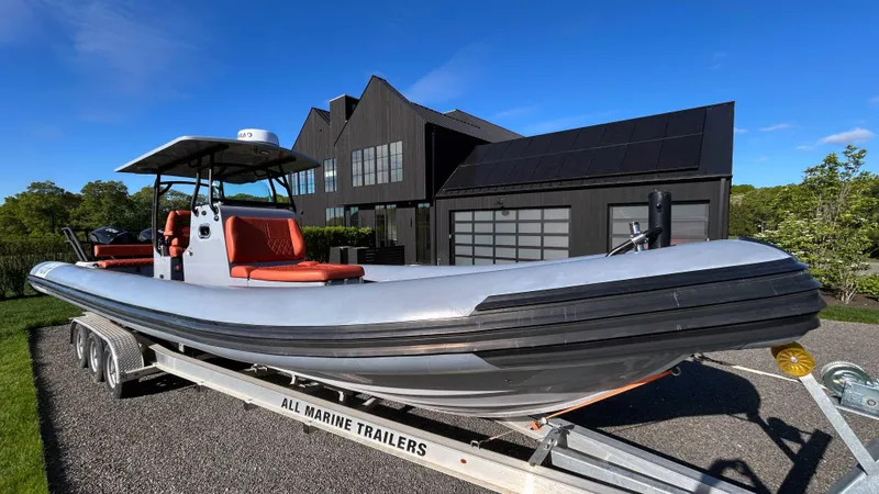 The Image of 2023 Fluid Watercraft M35 boat on trailer, parked in front of modern house. - 1