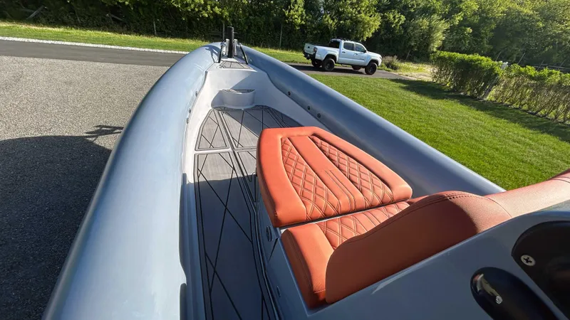Slide: The Image of 2023 Fluid Watercraft M35 boat with orange seats on a sunny day. - 10
