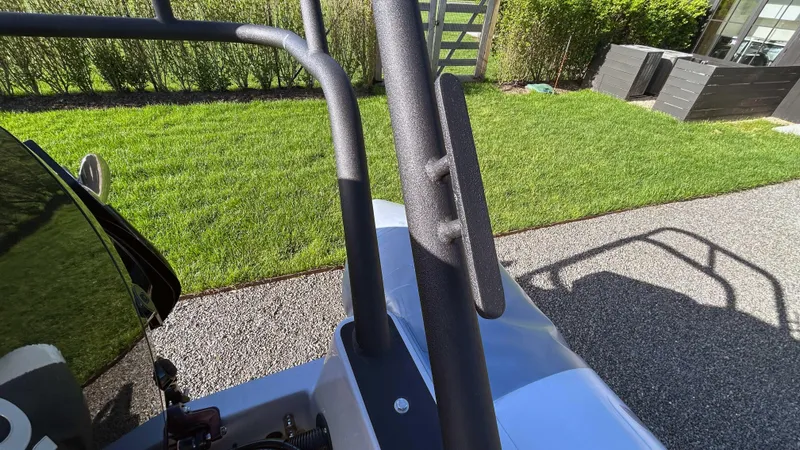 Slide: The Image of 2023 Fluid Watercraft M35 boat detail with sleek design, parked on a sunny lawn. - 15