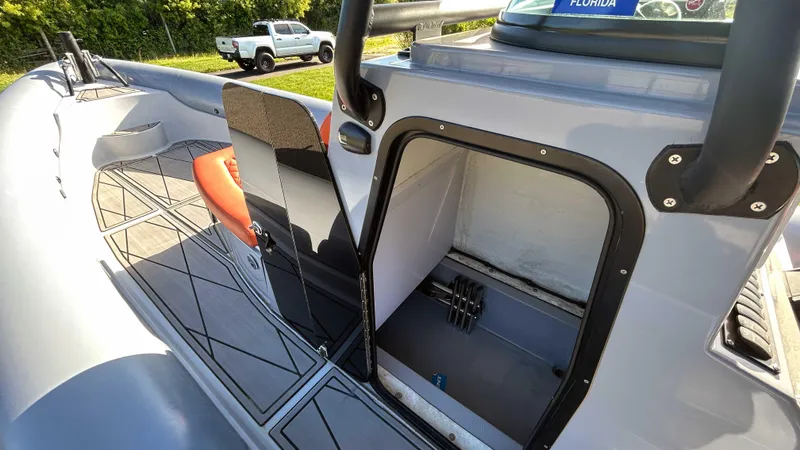 Slide: The Image of 2023 Fluid Watercraft M35 boat interior with storage compartment and seating. - 17