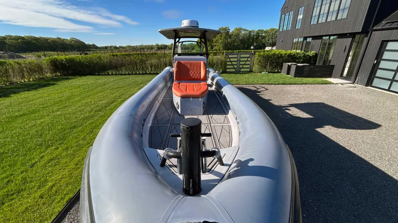 Slide: The Image of 2023 Fluid Watercraft M35 boat on grass near modern building, sunny day. - 23