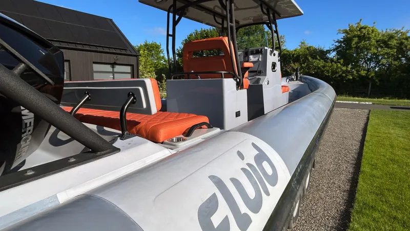 Slide: The Image of 2023 Fluid Watercraft M35 boat with orange seats, sleek design, and modern features. - 29