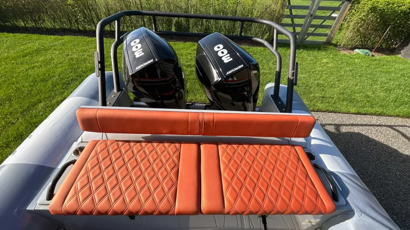 Slide: The Image of 2023 Fluid Watercraft M35 boat with dual engines and orange quilted seating. - 4