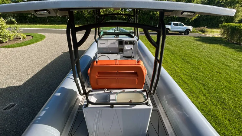 Slide: The Image of 2023 Fluid Watercraft M35 boat with orange seat and sleek design on a sunny day. - 5