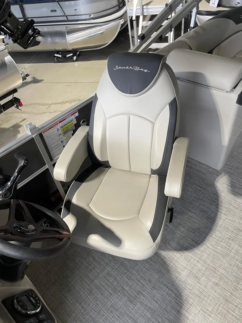 Slide: The Image of Captain's chair in 2023 South Bay 224RS LE pontoon boat, featuring sleek design and comfortable seating. - 5