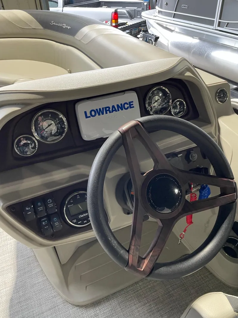 Slide: The Image of 2023 South Bay 224RS LE boat dashboard with Lowrance display and steering wheel. - 8