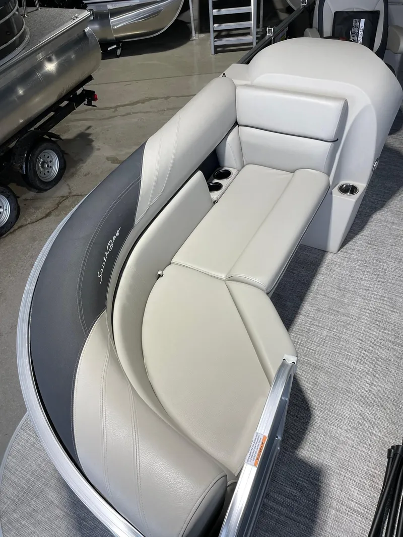 Slide: The Image of 2023 South Bay 224RS LE boat interior with curved seating and cup holders. - 9