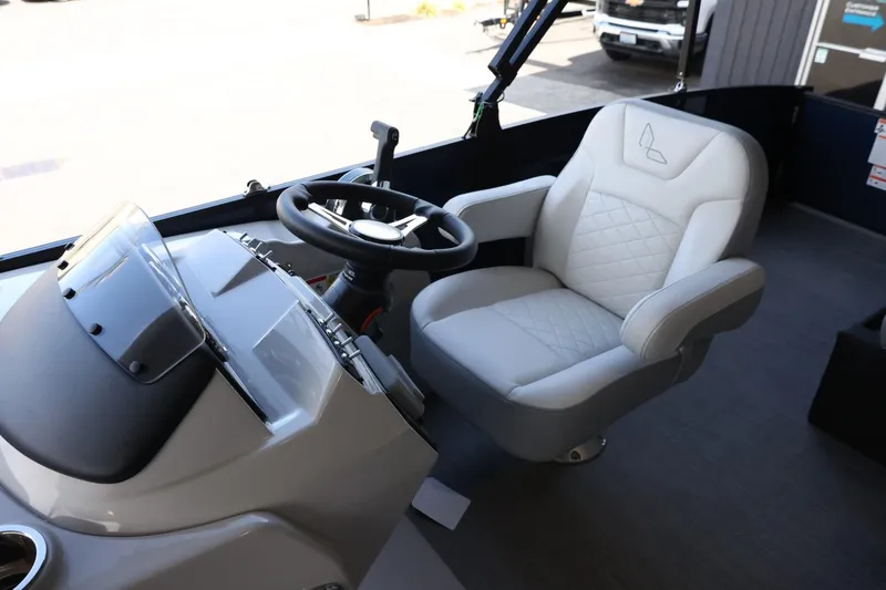 Slide: The Image of Captain's seat and helm of 2025 Lowe SS 230 DL boat, featuring modern design and controls. - 13