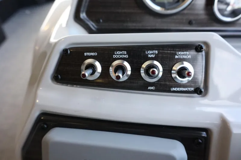Slide: The Image of Control panel of 2025 Lowe SS 230 DL boat with switches for stereo and lights. - 16