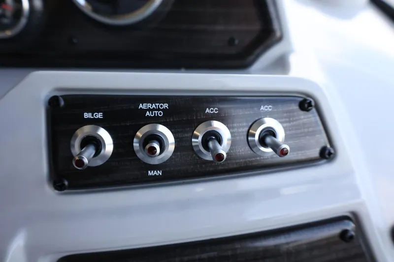 Slide: The Image of Control panel of 2025 Lowe SS 230 DL boat with switches for bilge, aerator, and accessories. - 17