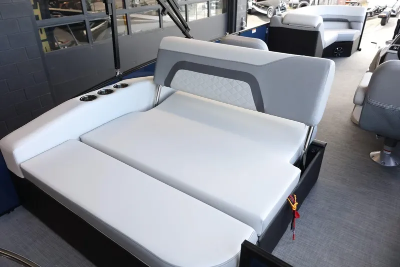 Slide: The Image of 2025 Lowe SS 230 DL boat interior with gray seating and cup holders. - 20
