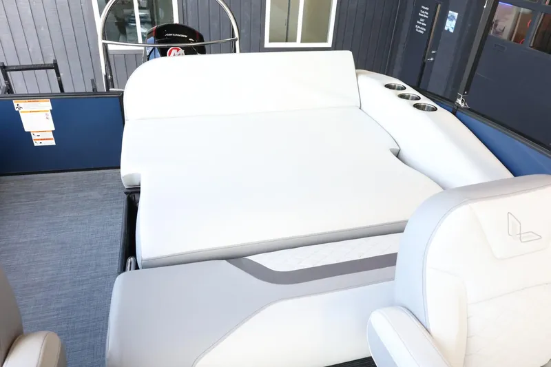 Slide: The Image of 2025 Lowe SS 230 DL boat interior with white seating and cup holders. - 23