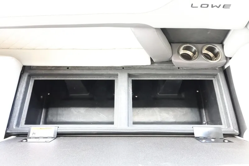 Slide: The Image of 2025 Lowe SS 230 DL storage compartment with dual cup holders. - 31