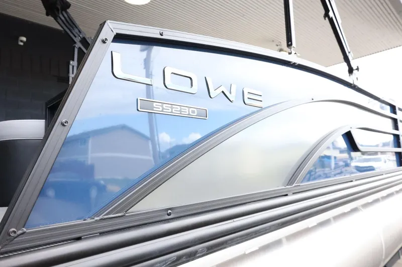 Slide: The Image of 2025 Lowe SS 230 DL pontoon boat with sleek blue and silver design. - 40