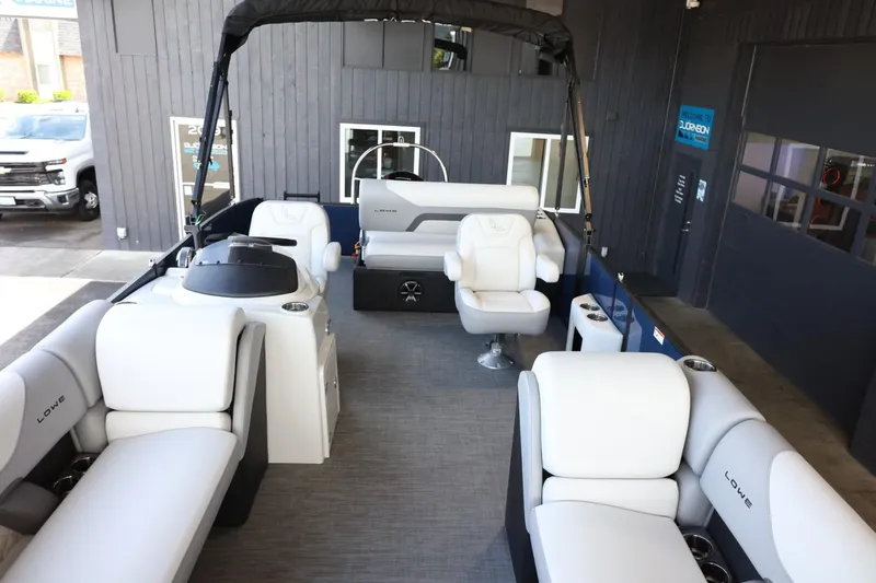 Slide: The Image of 2025 Lowe SS 230 DL pontoon boat interior with white seating and modern design. - 9