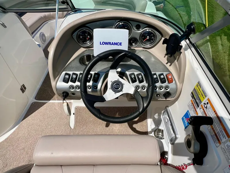Slide: The Image of 2013 Hurricane SunDeck 217 OB boat dashboard with steering wheel and control panel. - 12