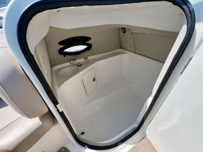 Slide: The Image of 2013 Hurricane SunDeck 217 OB boat interior cabin with sink and storage. - 13
