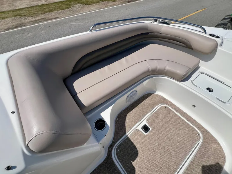 Slide: The Image of 2013 Hurricane SunDeck 217 OB boat with beige seating and carpeted floor. - 15