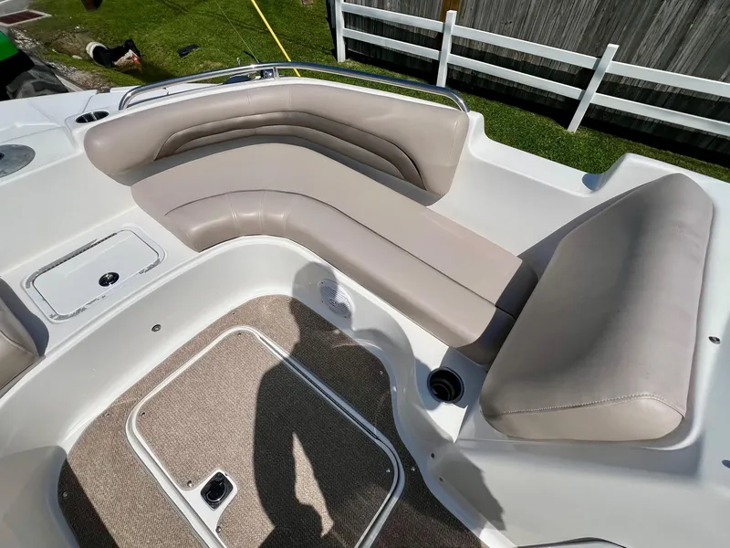 Slide: The Image of 2013 Hurricane SunDeck 217 OB boat interior with beige seating and carpeted flooring. - 16