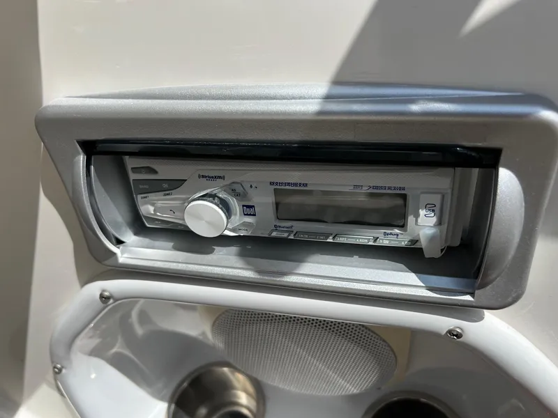 Slide: The Image of 2013 Hurricane SunDeck 217 OB boat stereo system with speaker and cup holder. - 20