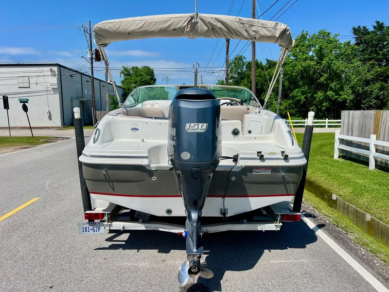 Slide: The Image of 2013 Hurricane SunDeck 217 OB boat on trailer, rear view with outboard motor. - 3