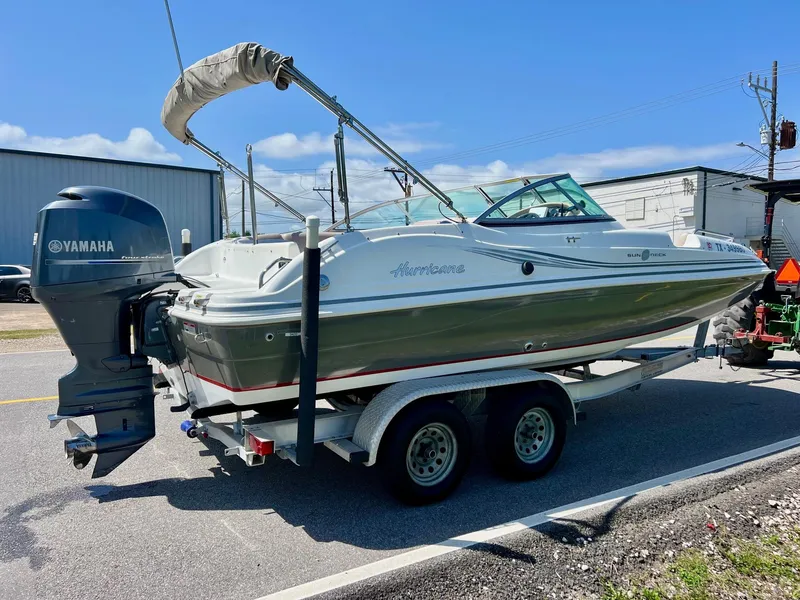 Slide: The Image of 2013 Hurricane SunDeck 217 OB boat on trailer with Yamaha outboard motor. - 4