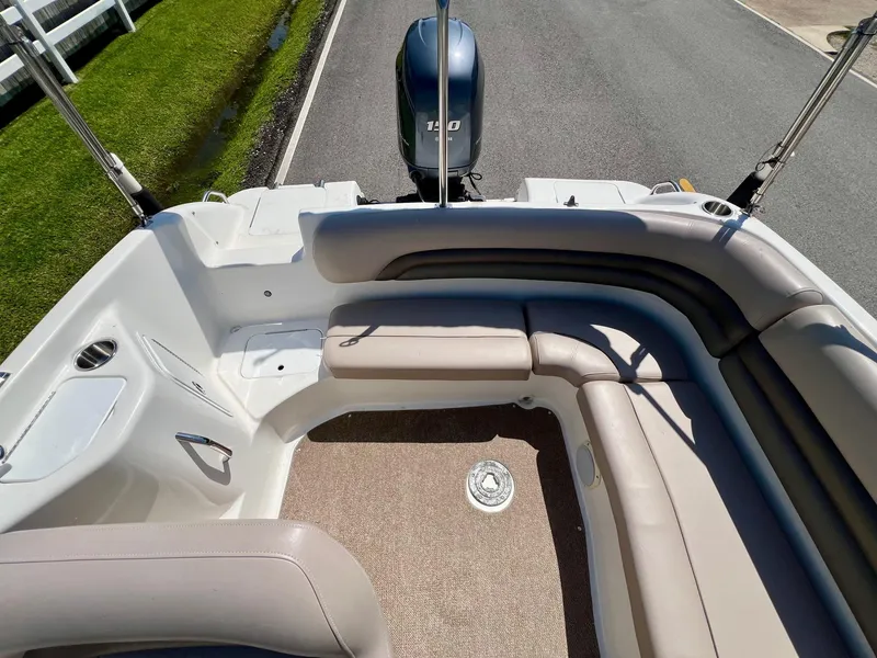 Slide: The Image of 2013 Hurricane SunDeck 217 OB boat interior with seating and outboard motor. - 7