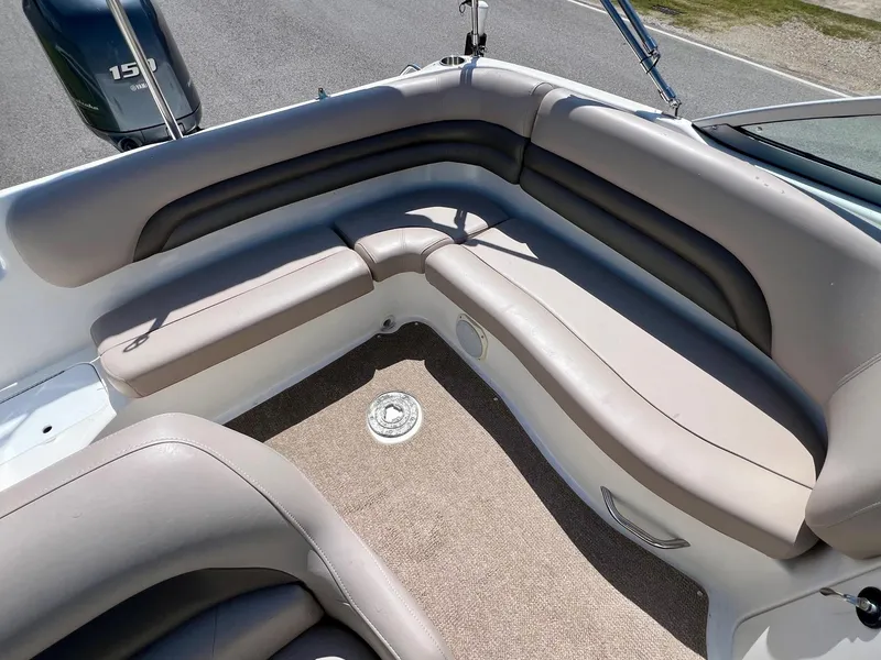 Slide: The Image of 2013 Hurricane SunDeck 217 OB boat interior with beige seating and carpeted floor. - 8