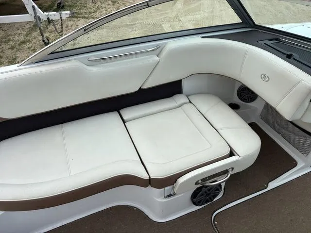 Slide: The Image of 2018 Cobalt 220S boat interior with white leather seating and brown accents. - 10