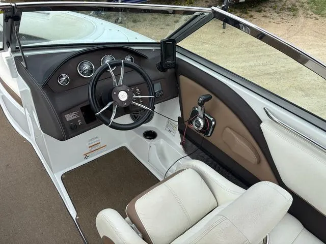 Slide: The Image of 2018 Cobalt 220S boat interior with steering wheel and control panel. - 11