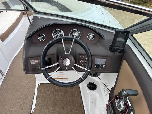 Slide: The Image of Steering wheel and dashboard of 2018 Cobalt 220S boat with gauges and controls. - 12