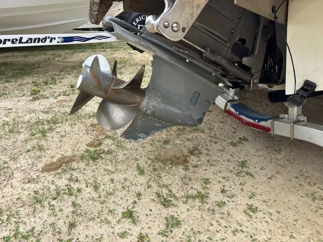 Slide: The Image of Propeller of a 2018 Cobalt 220S boat on a trailer, parked on sandy ground. - 17