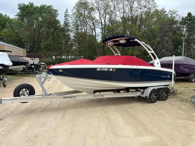 Slide: The Image of 2018 Cobalt 220S boat with red cover on trailer, parked outdoors. - 3