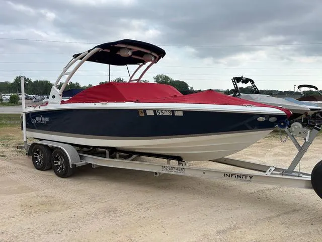Slide: The Image of 2018 Cobalt 220S boat with red cover on trailer, parked outdoors. - 4