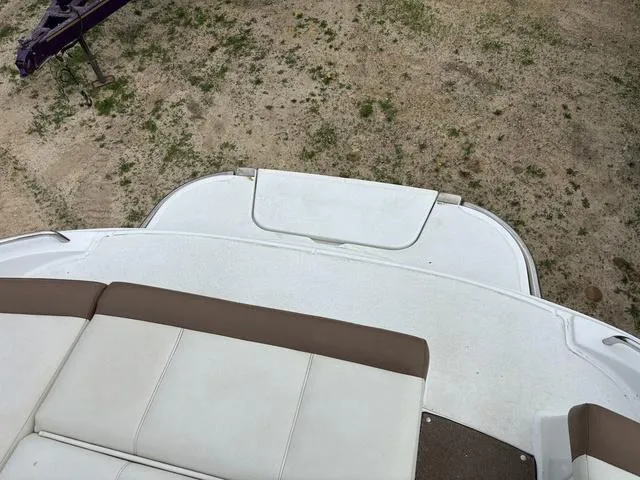 Slide: The Image of 2018 Cobalt 220S boat interior with white and brown seating, viewed from above. - 6