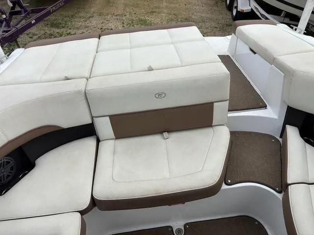 Slide: The Image of 2018 Cobalt 220S boat interior with beige and brown cushioned seating. - 7