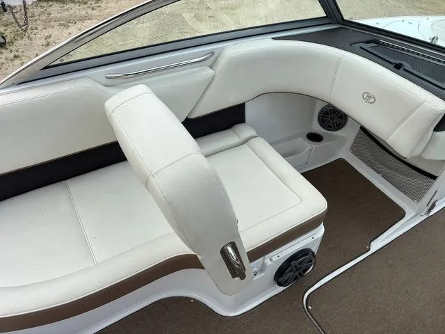 Slide: The Image of 2018 Cobalt 220S boat interior with white and brown seating, speaker, and carpeted floor. - 9