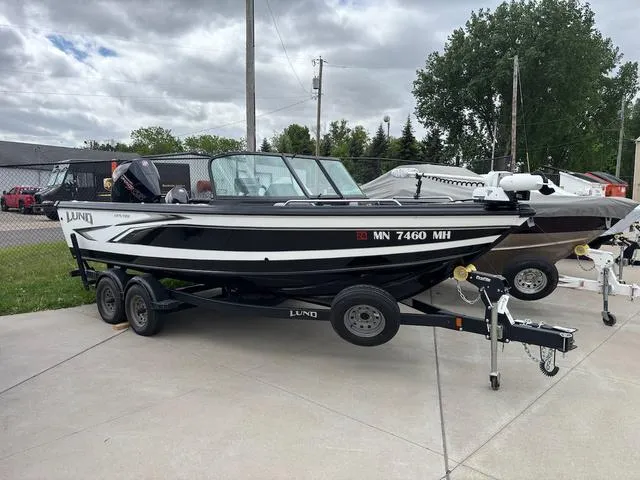 Slide: The Image of 2022 Lund 1975 Tyee Sport boat on trailer, parked outdoors. - 1