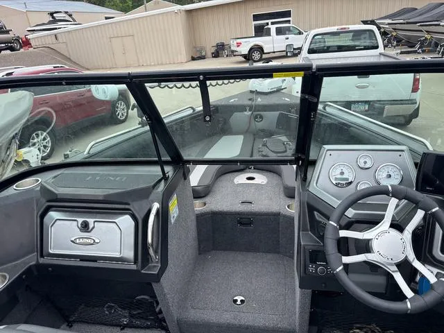 Slide: The Image of Interior view of a 2022 Lund 1975 Tyee Sport boat, featuring dashboard and steering wheel. - 12