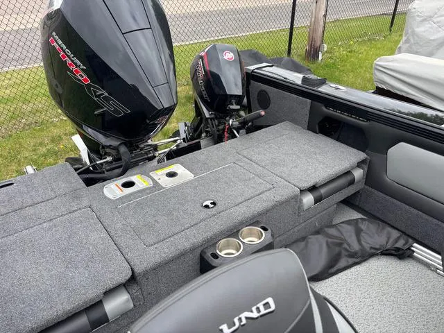 Slide: The Image of Lund 1975 Tyee Sport 2022 boat interior with dual motors and seating area. - 13