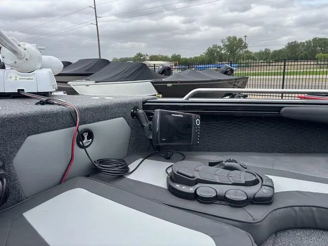 Slide: The Image of 2022 Lund 1975 Tyee Sport boat interior with navigation equipment and seating. - 16