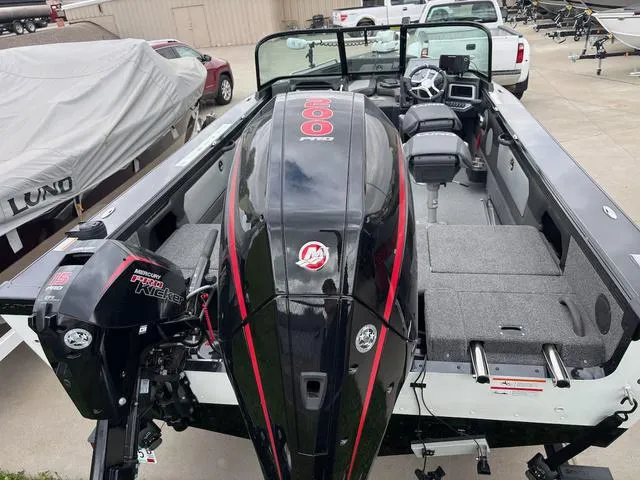 Slide: The Image of 2022 Lund 1975 Tyee Sport boat with powerful Mercury engine, parked outdoors. - 3