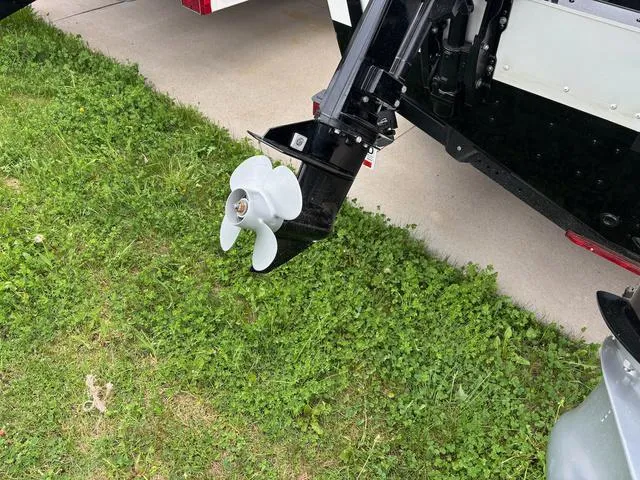 Slide: The Image of Outboard motor of 2022 Lund 1975 Tyee Sport on grass. - 5