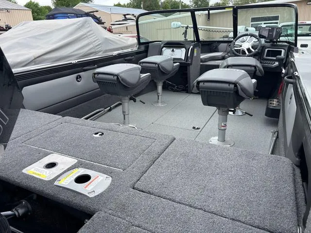 Slide: The Image of 2022 Lund 1975 Tyee Sport boat interior with seating and steering console. - 7