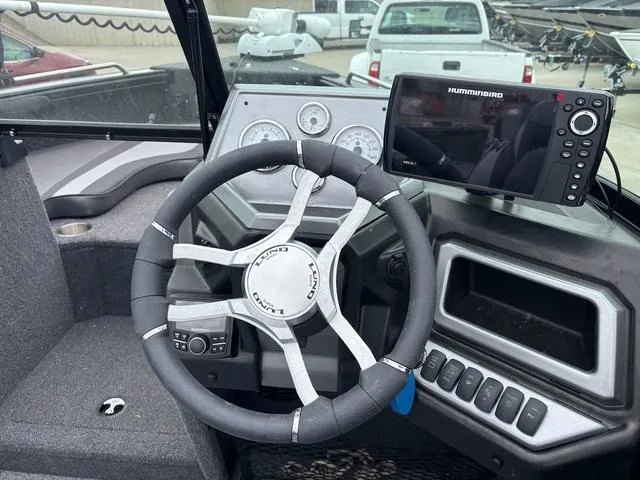 Slide: The Image of Steering wheel and dashboard of 2022 Lund 1975 Tyee Sport boat with Humminbird electronics. - 9