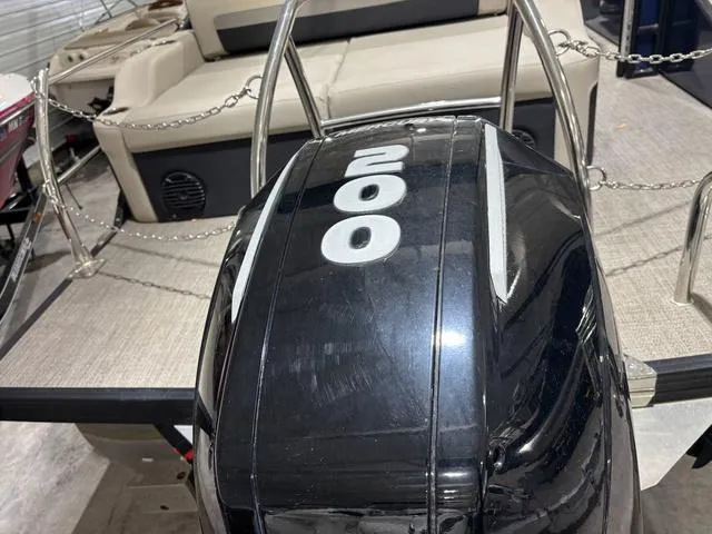 Slide: The Image of 2021 Barletta C24UC boat with 200 horsepower engine, beige seating, and metal railings. - 10