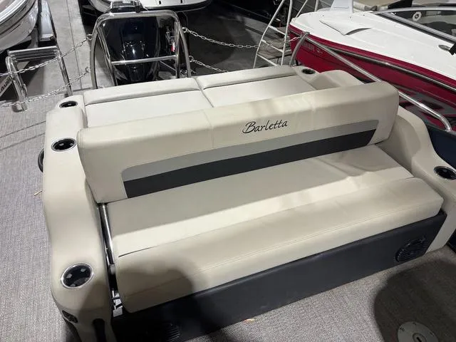 Slide: The Image of 2021 Barletta C24UC boat seating area with beige upholstery and cup holders. - 5